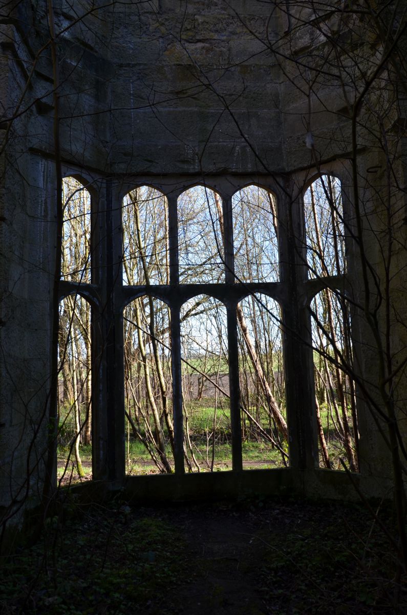 Inside the Dunmore house with view through a broken window